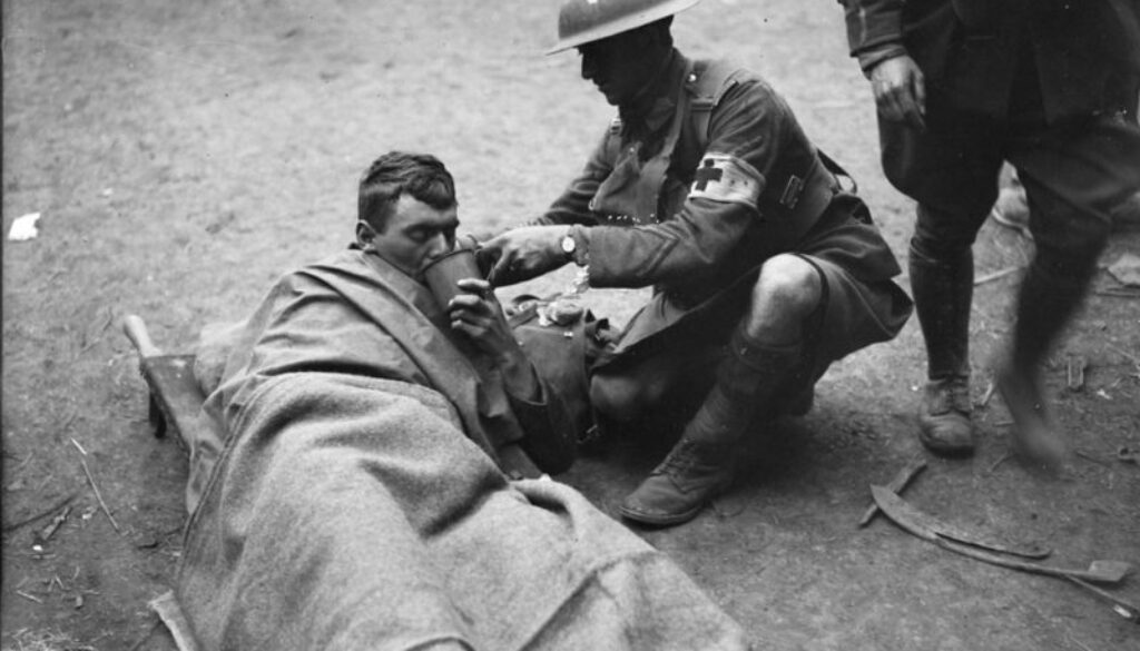 257_Wounded Canadian getting a drink from a stretcher bearer. Advance East of Arras. October, 1918.